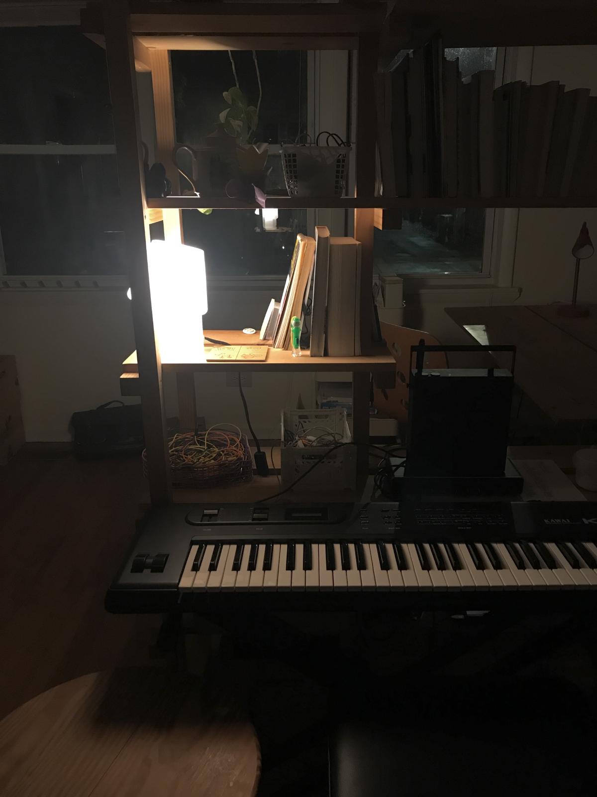 night shelf with a whte lamp keyboard in front