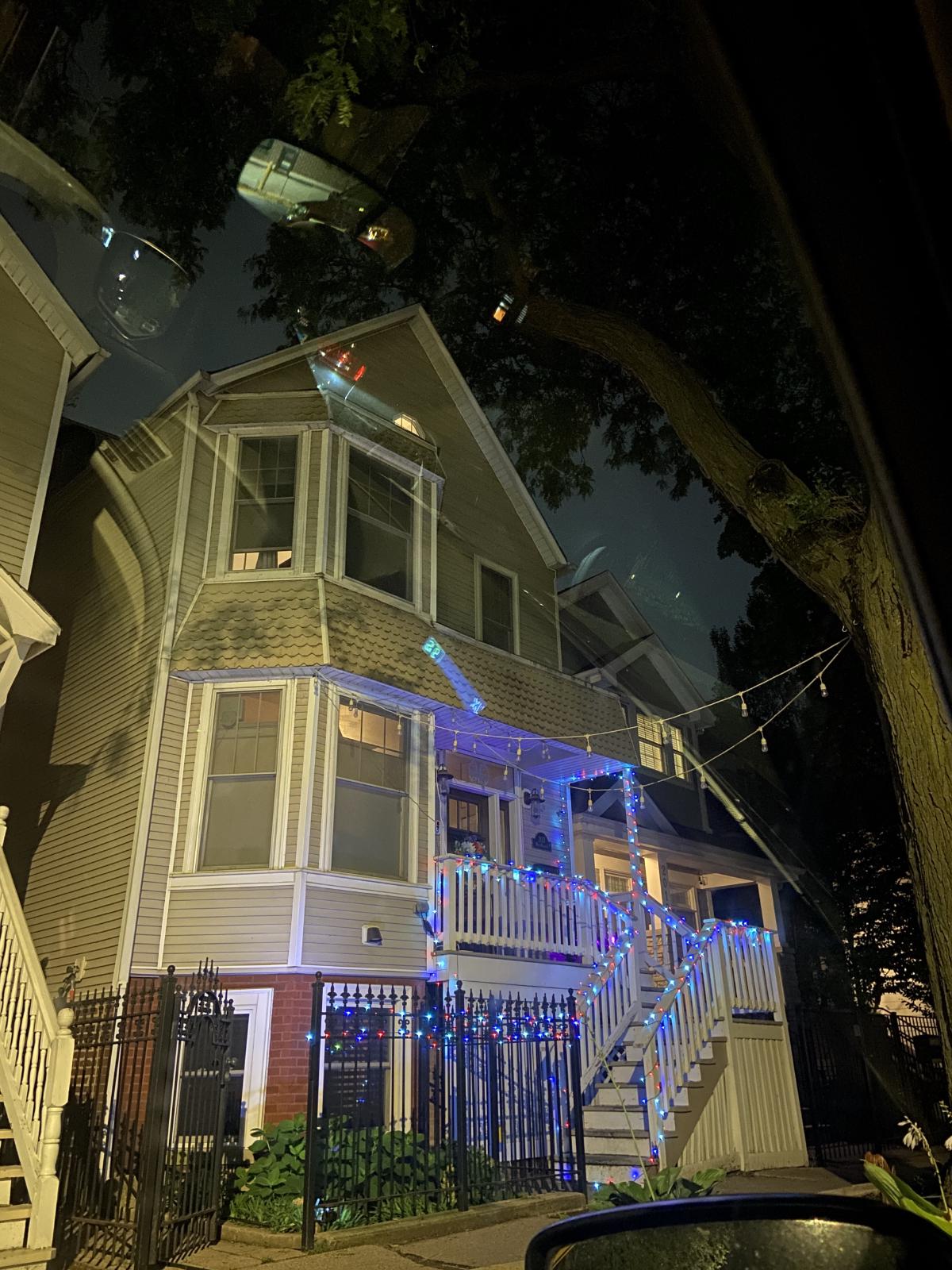 out of the car window my neighbors house with colored lights