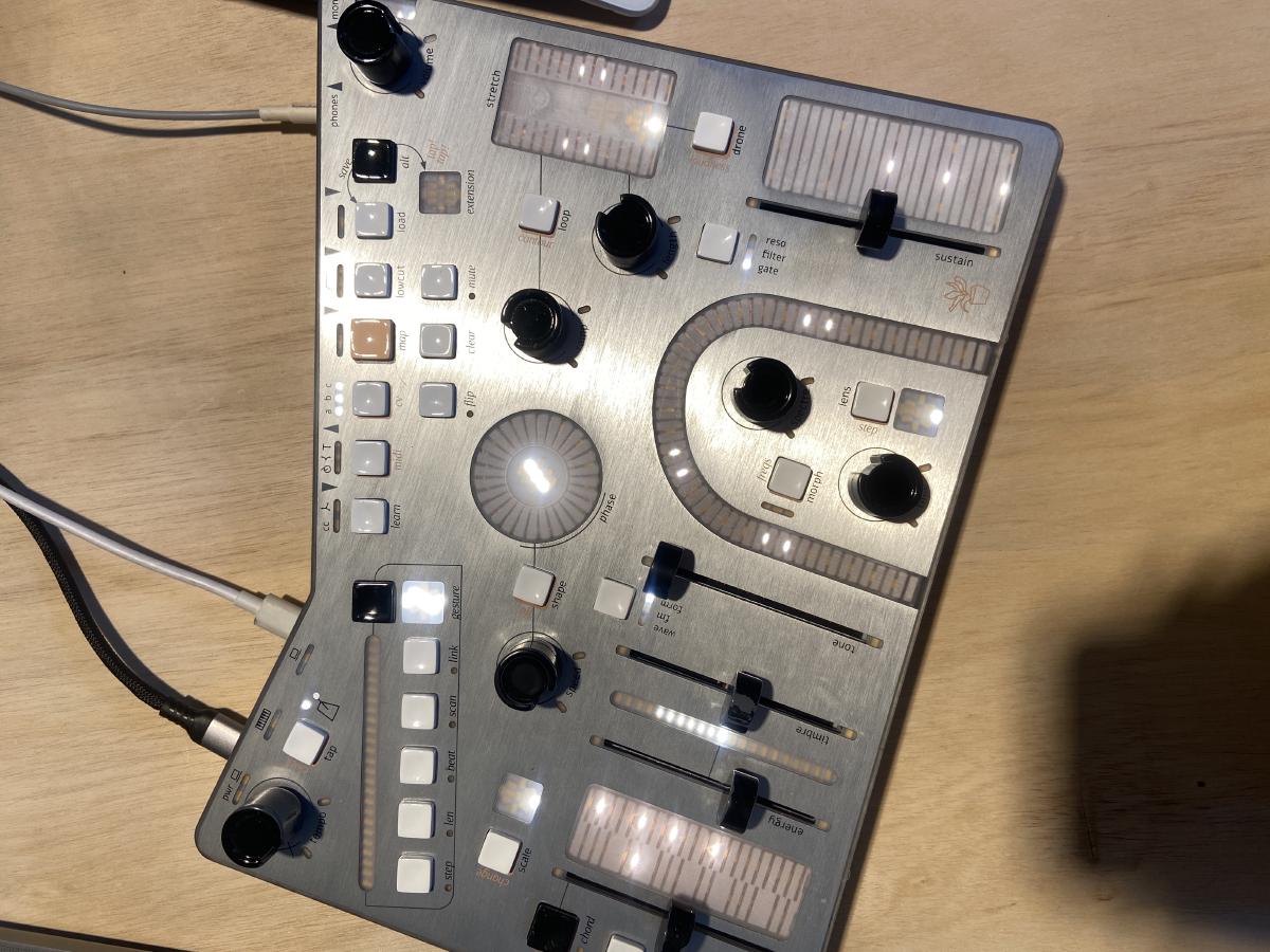 a metal instrument with many sliders knobs and lights