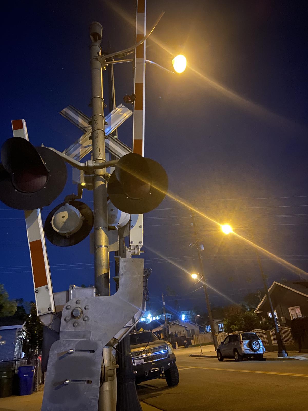 night with railroad crossong and street lights